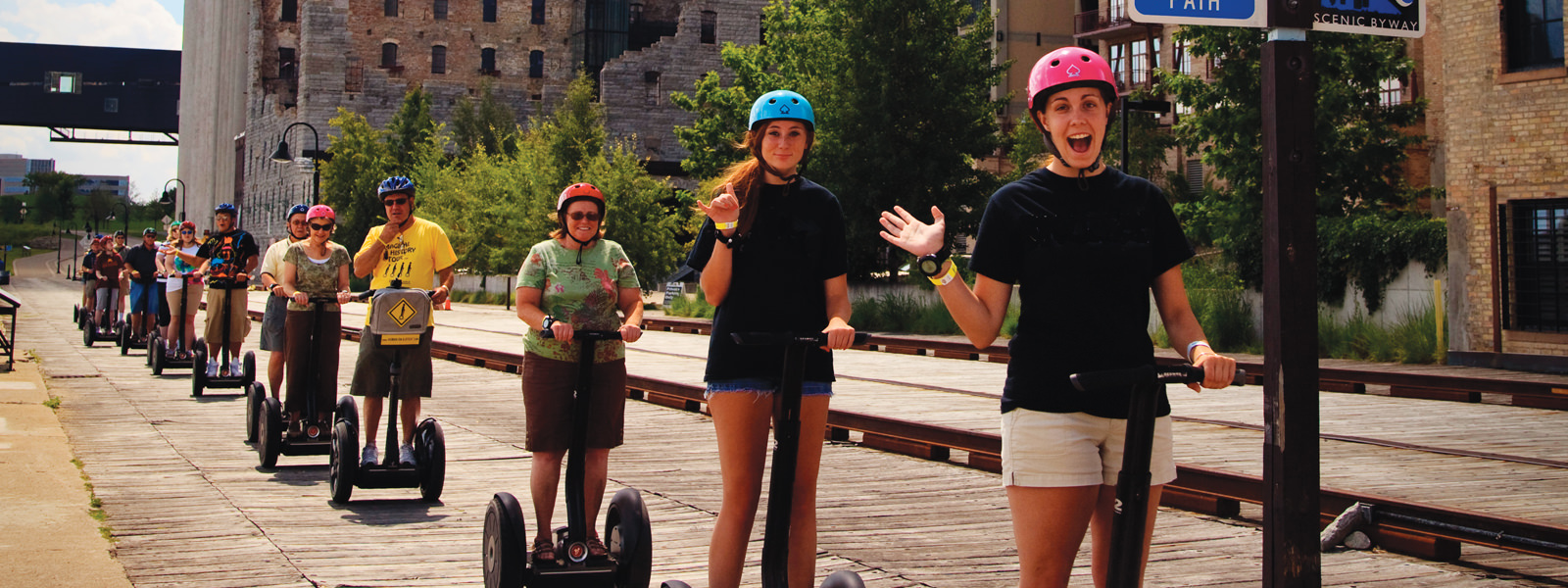 HumanOnAStick riders smiling along the Minneapolis riverfront
